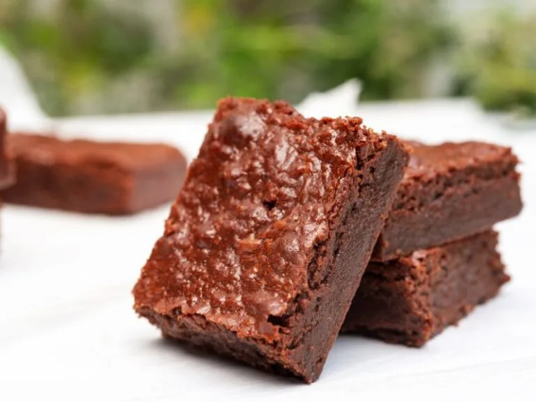 Freshly baked fudgy chocolate brownie with a crackly top, rich cocoa flavor, and a moist, gooey center.